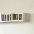 White wall shelf with four cubbies displaying CD spines in organized rows