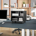 Black printer cabinet with front shelves and casters in an office setting