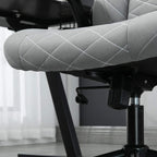 Light grey quilted chair seat close-up with side control lever and gas-lift base