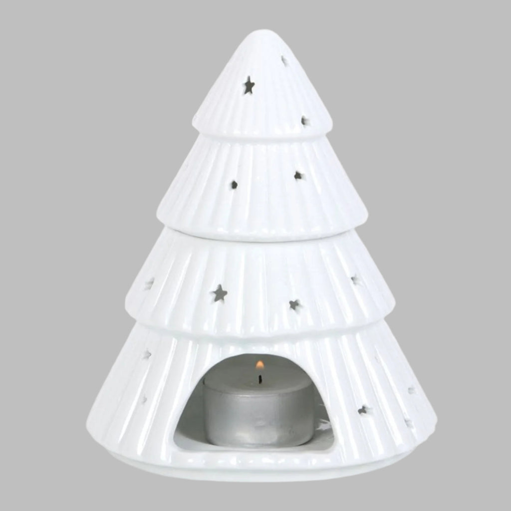 White pine tree-shaped candle holder with a small candle inside on a white background