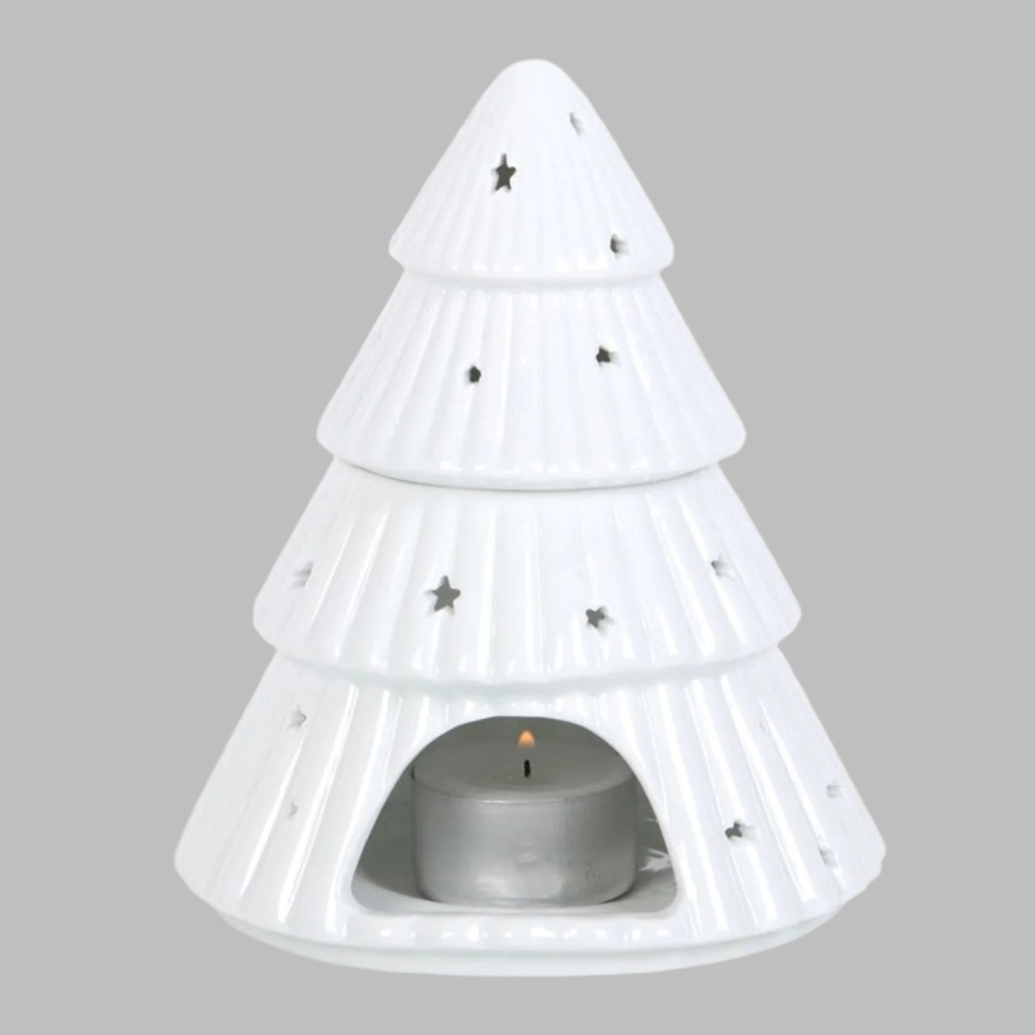 White pine tree-shaped candle holder with a small candle inside on a white background