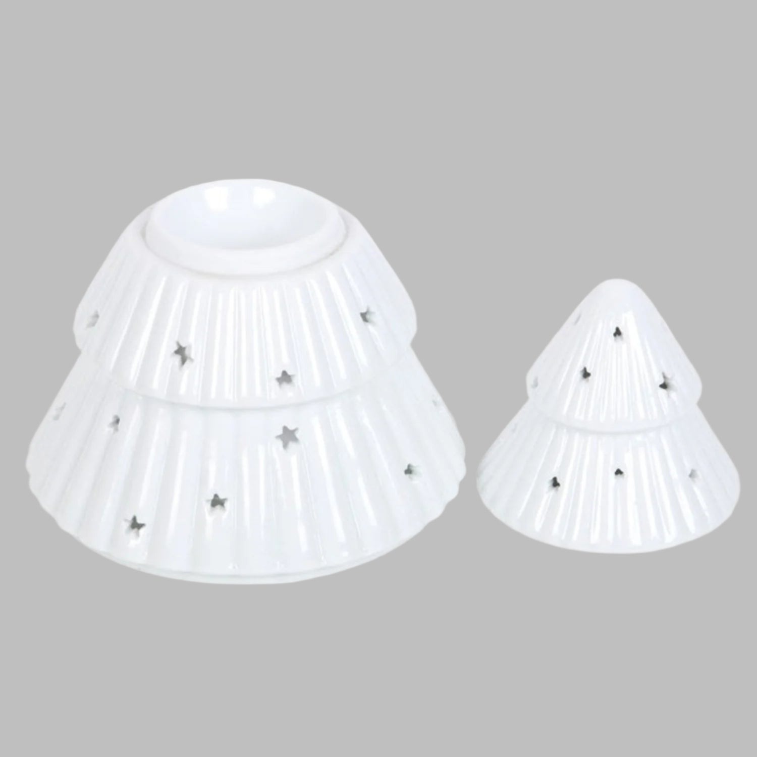 Two white plastic cones with star-shaped holes on a white background