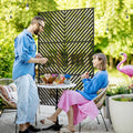 Black metal triangle-pattern outdoor privacy screen as a freestanding divider