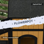 Wooden cat house with black asphalt-style roof and built-in flower pot planter opening