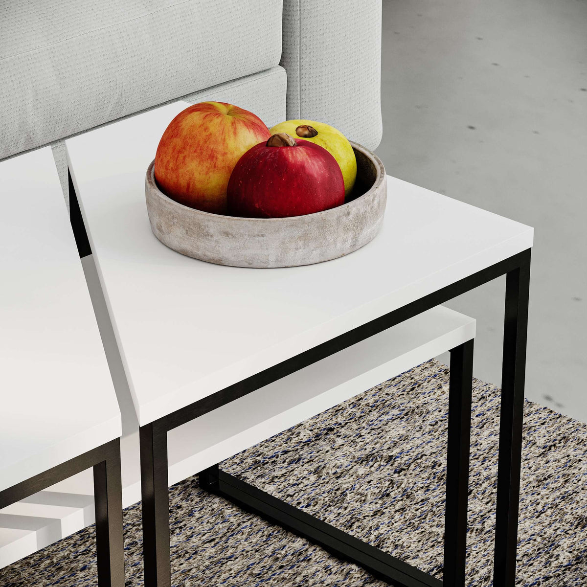 White top modern coffee table with black metal frame and fruit on top