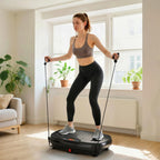Black vibration platform exercise machine with resistance bands and standing person