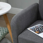 Grey fabric sofa armrest close-up with magazine on the seat cushion