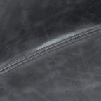 Close-up of dark grey PU leather bar stool seat seam with contrast stitching