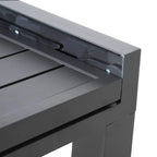 Dark grey tabletop edge close-up with recessed slot detail and connecting frame panel