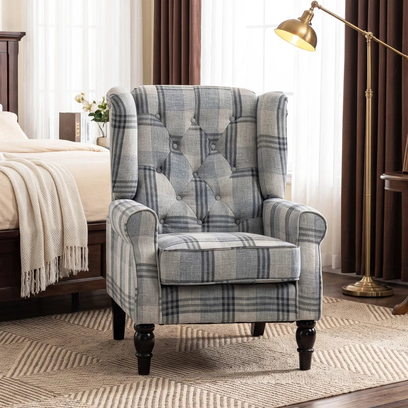 Wingback accent chair with blue-gray plaid upholstery, rolled arms, and dark legs