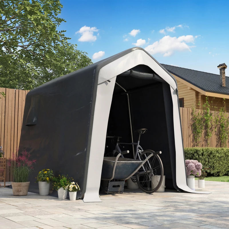 Grey storage shed tent with open front door on patio with garden plants
