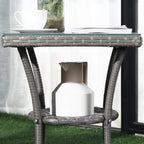 Grey woven rattan coffee table with glass top and lower shelf with storage box