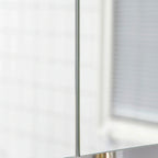 Close-up of the vertical seam on a white two-door bathroom mirror cabinet.