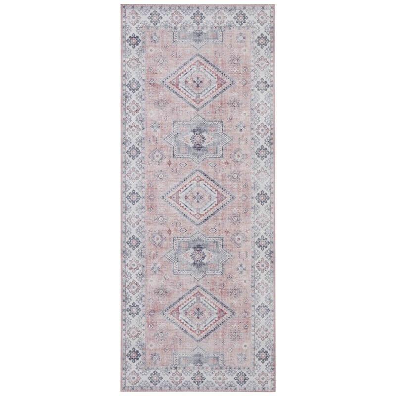 Narrow pink runner rug with stacked diamond medallion motifs and patterned ends