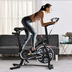 Black stationary exercise bike with adjustable seat and handlebars, in-use