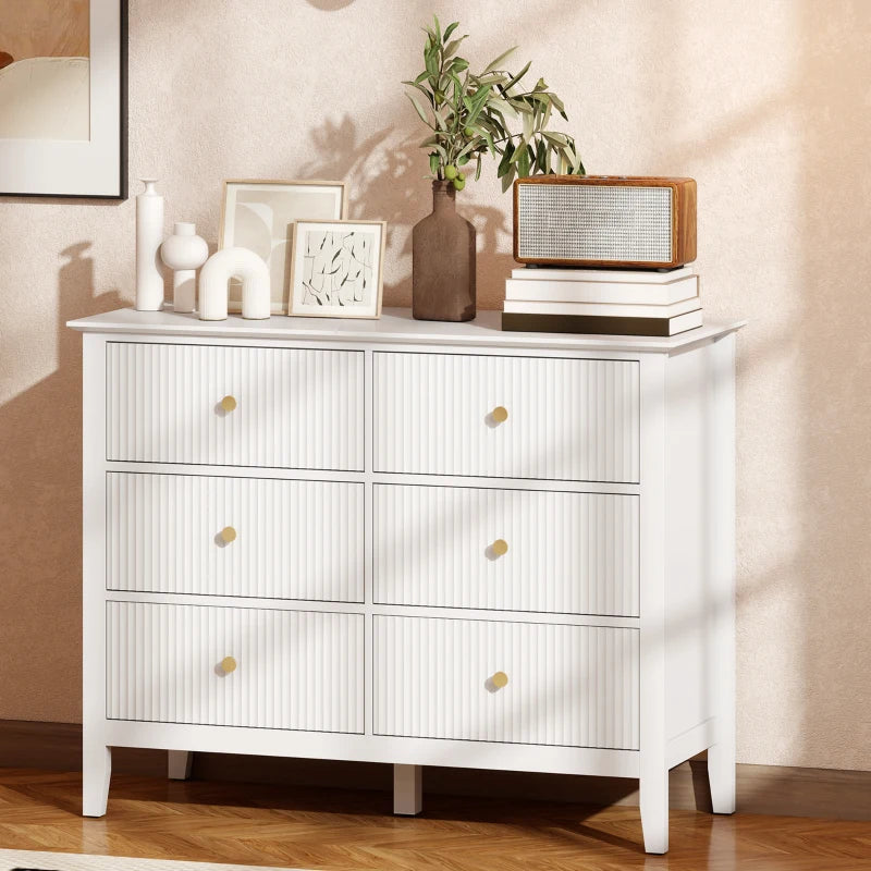 White fluted 6-drawer dresser with three rows of drawers and gold round knobs
