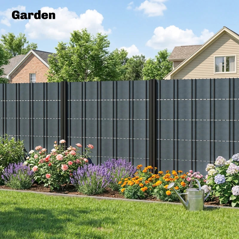 Grey privacy screen fence along a garden area with vertical panel grid