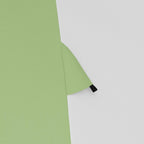 Green and grey tent fabric seam with corner reinforcement and stitched edge