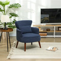 Blue corduroy accent armchair with curved arms, rounded back, and dark wood legs