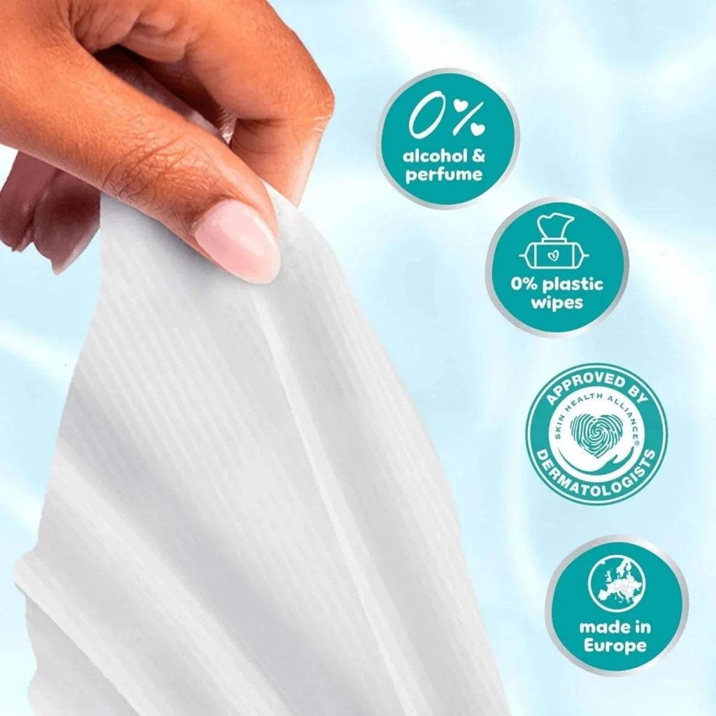 Hand pulling a baby wipe from plastic-free Pampers pack, alcohol & perfume free