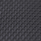 Black woven trampoline mat surface with tightly spaced spring loops