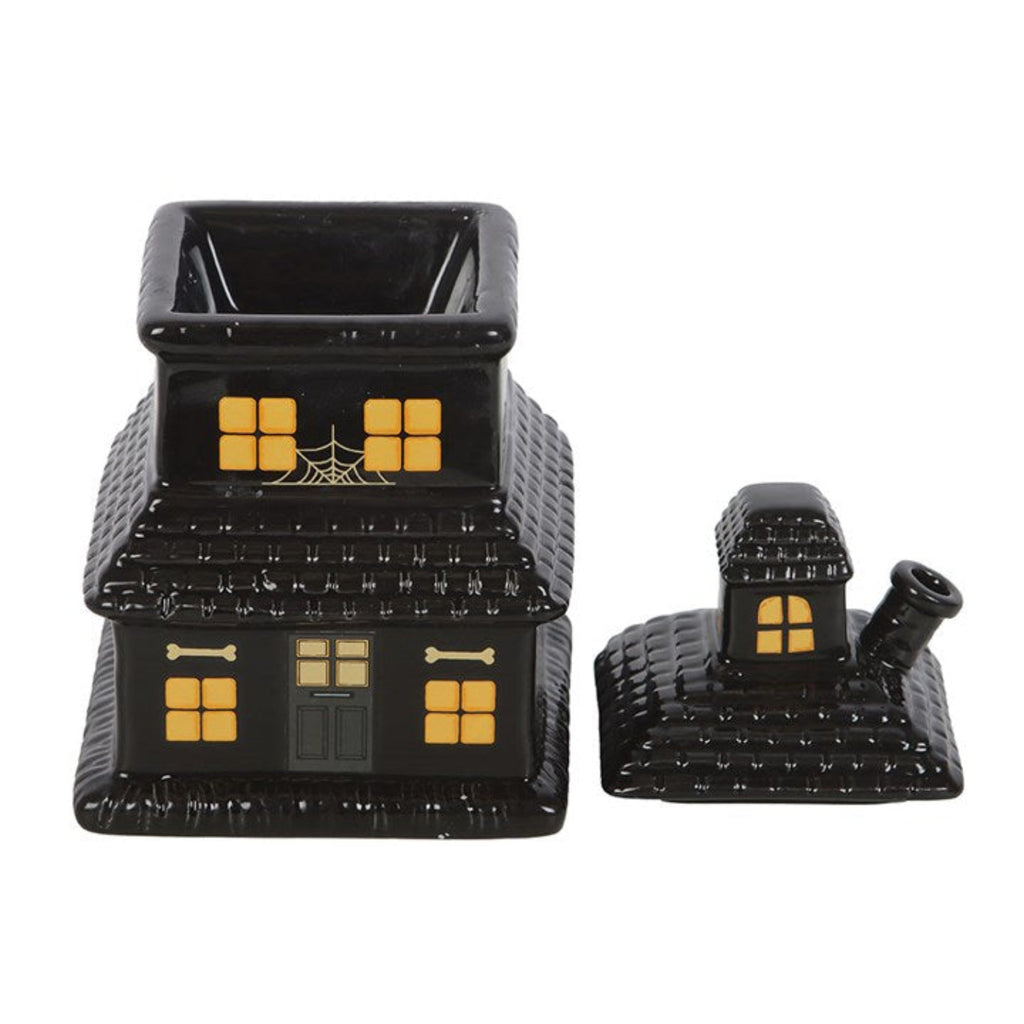 Black Halloween-themed candy house with yellow details on a white background