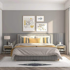 White nightstand with light wood drawer and open shelf beside a bed, on wooden legs.