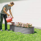 Gray galvanized metal raised garden bed with flowers, on outdoor grass