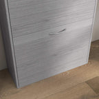 Close-up of grey wood-effect shoe cabinet drawer with curved metal handle