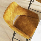 Close-up of brown velvet-look bar stool seat and back with quilted upholstery texture