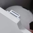 Close-up of grey toy box lid handle for lifting and closing the chest.