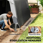 Grey storage shed tent staked to the ground using expansion bolts and stakes