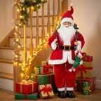 Red Santa figurine standing upright, white beard, black belt, holding green gift sack