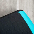 Textured non-slip aerobic step top with hex pattern and blue side trim