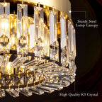 Gold-tone crystal chandelier close-up with clear prisms and metallic lamp canopy