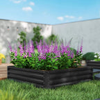 Square raised garden bed with dark grey metal frame, planted with purple flowers