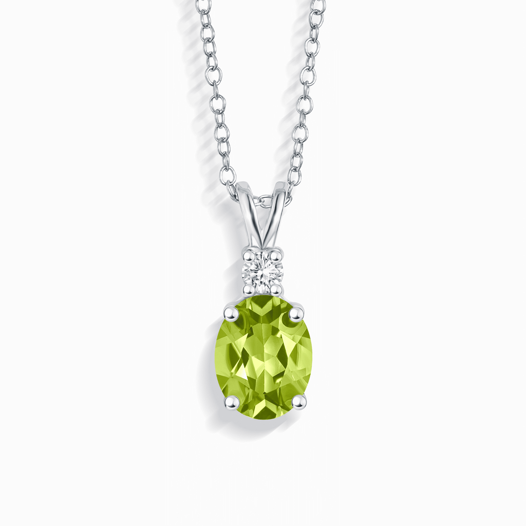 Sterling silver pendant necklace with green oval gemstone and small clear stones