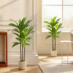 Green artificial dracaena tree with bendable trunks in a white planter pot.