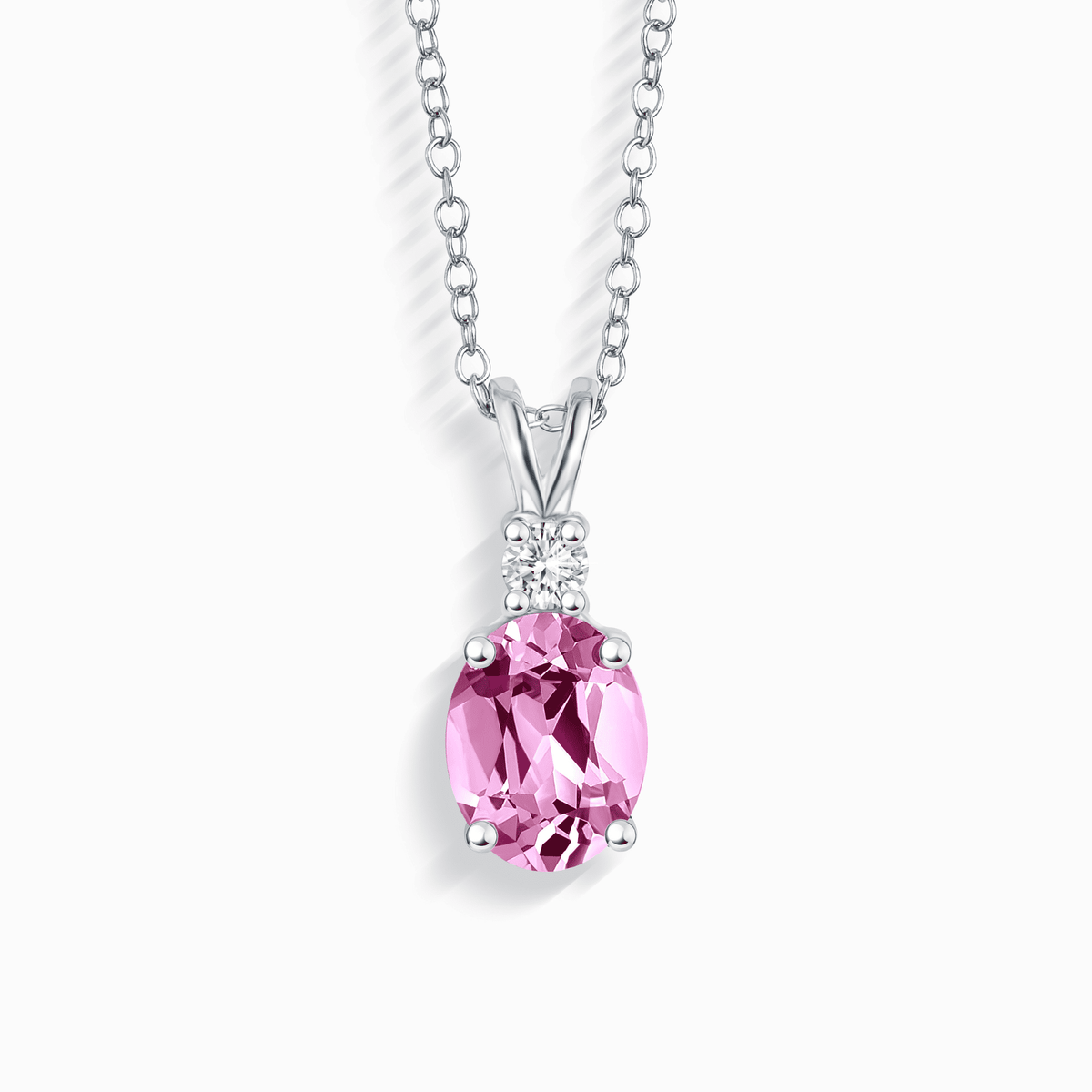 Sterling silver pendant necklace with pink oval sapphire and small halo stones
