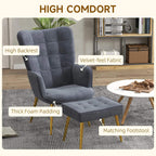 Dark grey wingback accent chair with ottoman and thick padding, gold-tone legs