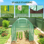 Green polytunnel greenhouse over garden beds with mesh walls and arched frame