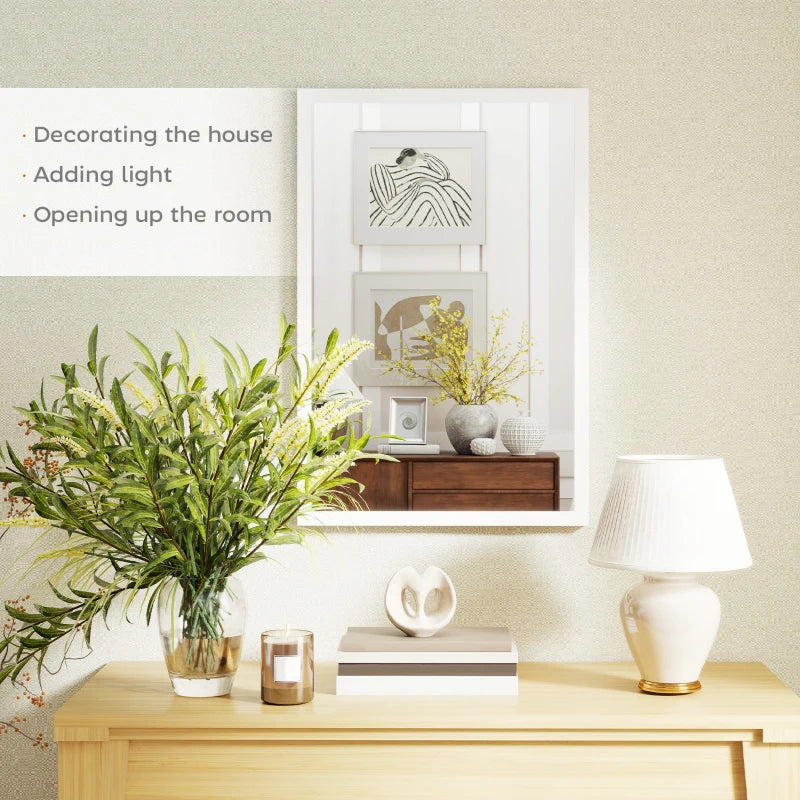 White framed wall mirror reflecting room decor and light-colored interior