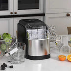 Black countertop ice maker on counter with clear bin and included ice scoop
