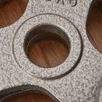 Close-up of cast iron weight plate center hole with textured metal finish