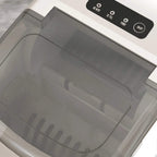 Close-up of white ice maker interior with open top lid and control buttons on panel