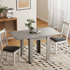 Grey extendable dining table with white chairs around it.