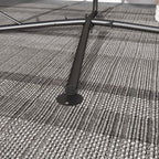 Black hammock chair stand base with circular foot pad on woven rug
