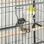 Close-up of dark grey bird cage door latch and wire bars with a small bird nearby