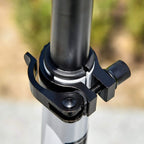 White folding kick scooter fork clamp with adjustment lever near handlepost