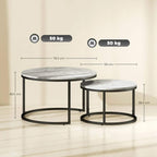 Two round nesting tables with grey marble-effect tops and black frames; one stacks under
